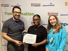 Dr. Jihad Kudsi presents a weight loss achievement certificate to a bariatric surgery patient at UChicago AdventHealth's Bariatric and Obesity Medicine Clinic in LaGrange