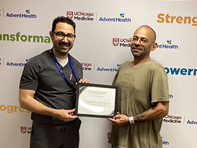 Dr. Jihad Kudsi presents a weight loss achievement certificate to a bariatric surgery patient at UChicago AdventHealth's Bariatric and Obesity Medicine Clinic in LaGrange