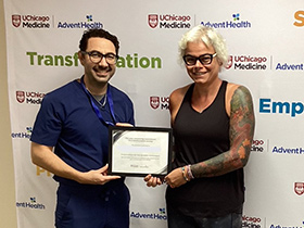 Dr. Jihad Kudsi presents a weight loss achievement certificate to a bariatric surgery patient at UChicago AdventHealth's Bariatric and Obesity Medicine Clinic in LaGrange