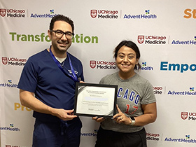 Dr. Jihad Kudsi presents a weight loss achievement certificate to a bariatric surgery patient at UChicago AdventHealth's Bariatric and Obesity Medicine Clinic in LaGrange