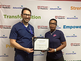 Dr. Jihad Kudsi presents a weight loss achievement certificate to a bariatric surgery patient at UChicago AdventHealth's Bariatric and Obesity Medicine Clinic in LaGrange