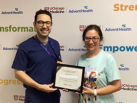 Dr. Jihad Kudsi presents a weight loss achievement certificate to a bariatric surgery patient at UChicago AdventHealth's Bariatric and Obesity Medicine Clinic in LaGrange