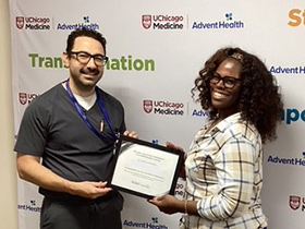 Dr. Jihad Kudsi presents a weight loss achievement certificate to a bariatric surgery patient at UChicago AdventHealth's Bariatric and Obesity Medicine Clinic in LaGrange